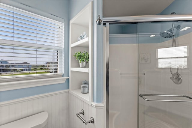 4114 Courageous Ln, Galveston, TX 77554 - bathroom with a shower stall, wainscoting, and toilet