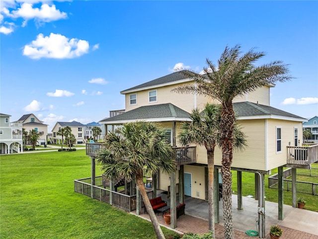 4114 Courageous Ln, Galveston, TX 77554 - rear view of house with a carport, a residential view, roof with shingles, a patio area, and a wooden deck