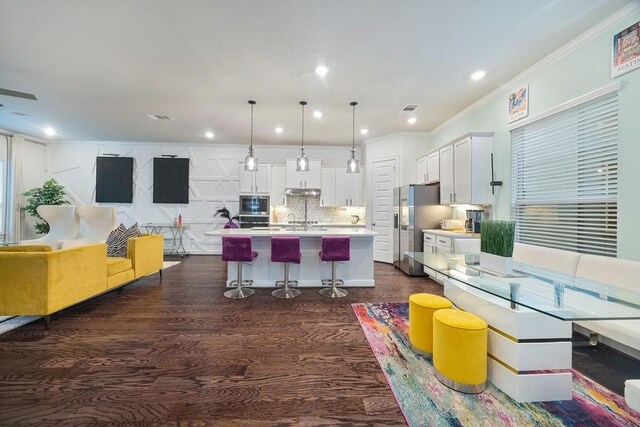 4008 Centre Glen Dr, Houston, TX 77043 - kitchen featuring appliances with stainless steel finishes, open floor plan, white cabinetry, light countertops, and a breakfast bar