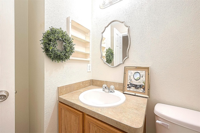 3422 Glenmore Meadow Dr, Spring, TX 77386 - half bathroom featuring toilet, vanity, and a textured wall
