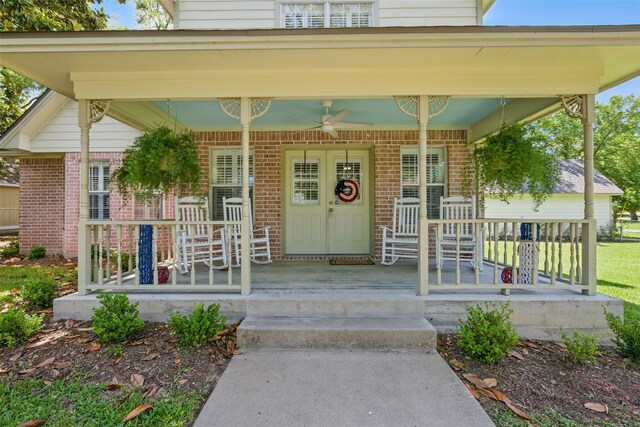 407 W Main St, Brenham, TX 77833 - view of exterior entry with covered porch, brick siding, and a ceiling fan