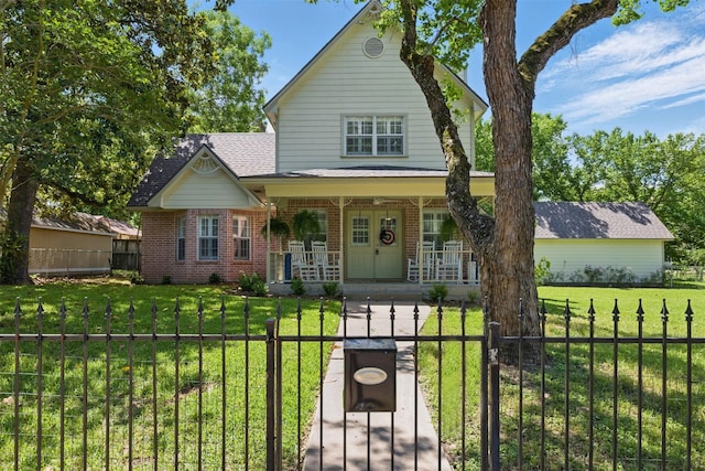 407 W Main St, Brenham, TX 77833 - view of front of house featuring brick siding, a porch, and a gate