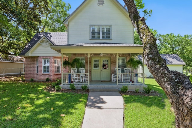 407 W Main St, Brenham, TX 77833 - view of front of home with a porch, brick siding, and a front yard