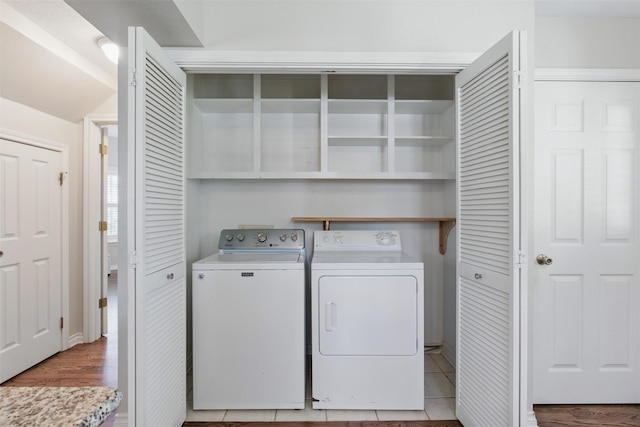 407 W Main St, Brenham, TX 77833 - laundry room with washer and clothes dryer and light wood-type flooring