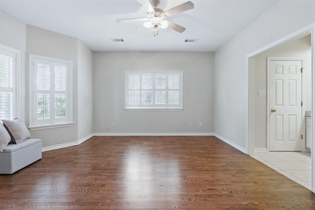 407 W Main St, Brenham, TX 77833 - unfurnished living room with a ceiling fan, wood finished floors, and baseboards