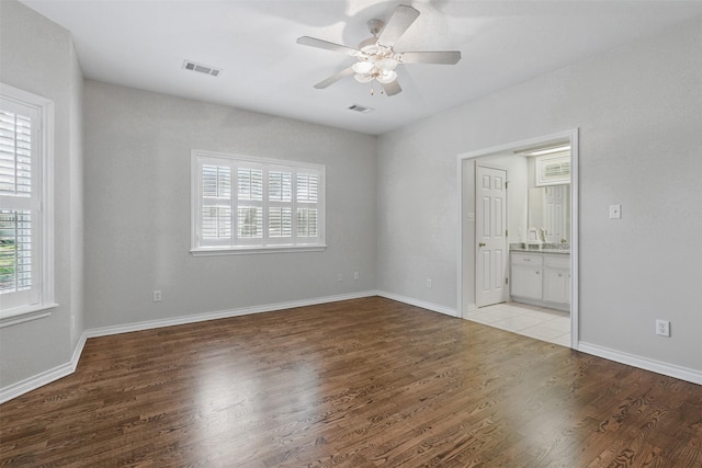 407 W Main St, Brenham, TX 77833 - unfurnished room with ceiling fan, light wood-type flooring, and baseboards