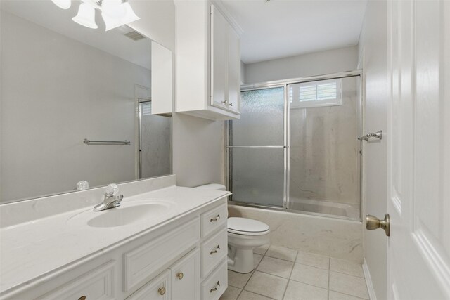 407 W Main St, Brenham, TX 77833 - bathroom featuring toilet, tile patterned floors, shower / bath combination with glass door, and vanity