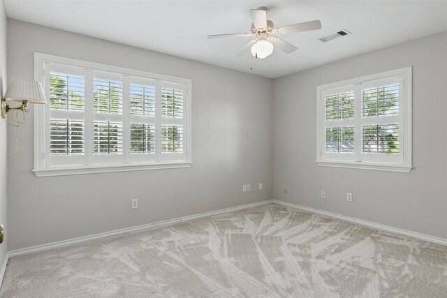 407 W Main St, Brenham, TX 77833 - carpeted empty room featuring plenty of natural light, baseboards, and ceiling fan