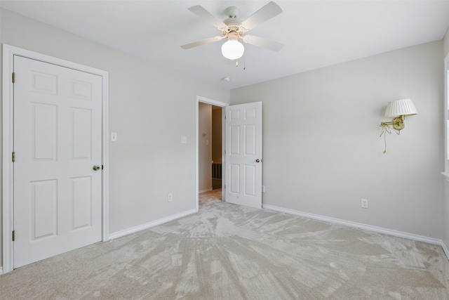 407 W Main St, Brenham, TX 77833 - unfurnished bedroom featuring carpet flooring, baseboards, and a ceiling fan