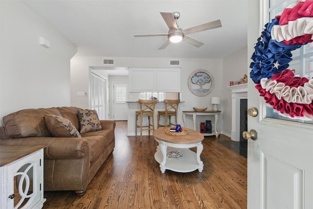 407 W Main St, Brenham, TX 77833 - living area featuring wood finished floors, ceiling fan, and a fireplace