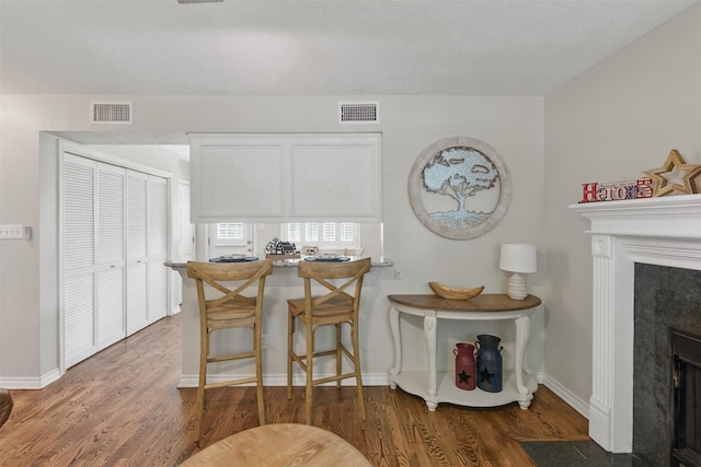 407 W Main St, Brenham, TX 77833 - dining room featuring wood finished floors, baseboards, and a fireplace with flush hearth