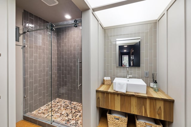 827 Magnolia St, Livingston, TX 77351 - bathroom featuring a stall shower, vanity, tile walls, tasteful backsplash, and recessed lighting