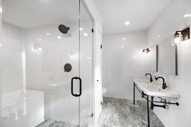 827 Magnolia St, Livingston, TX 77351 - bathroom featuring toilet, a tub, a shower stall, a sink, and recessed lighting