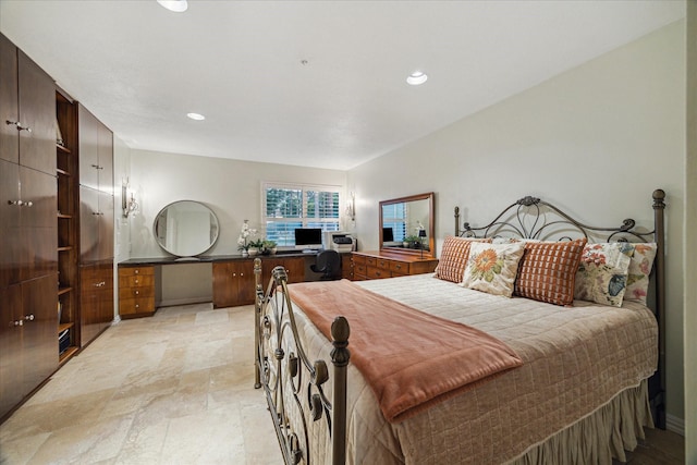 bedroom featuring light stone finish flooring, recessed lighting, and an office area