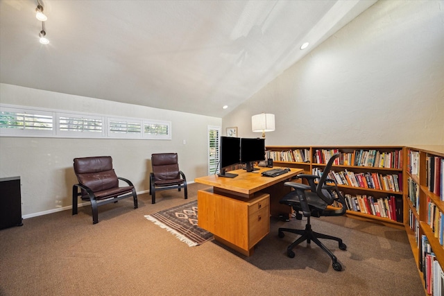 carpeted home office with lofted ceiling and baseboards