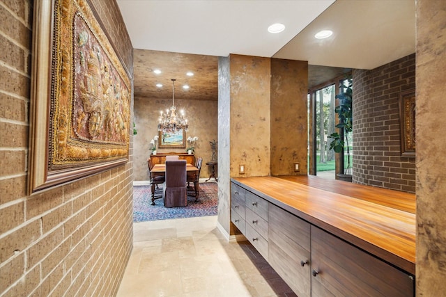 bathroom with a chandelier, recessed lighting, vanity, and stone finish floors