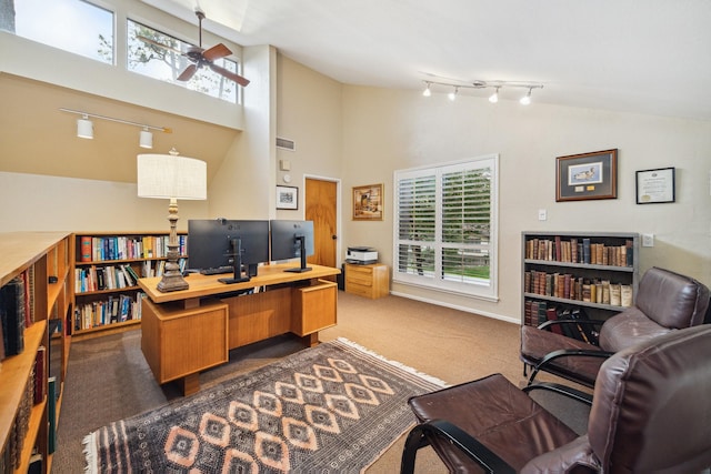 office with dark colored carpet, ceiling fan, track lighting, and high vaulted ceiling