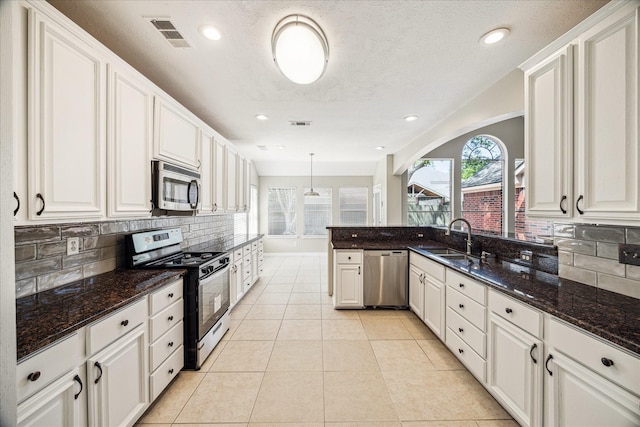 17426 Little Riata Dr, Houston, TX 77095 - kitchen with stainless steel appliances, a sink, tasteful backsplash, white cabinetry, and recessed lighting