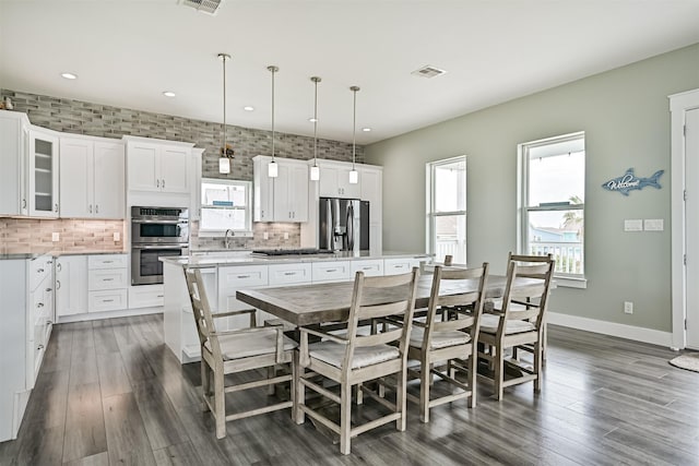 16631 Jean Lafitte Rd, Galveston, TX 77554 - dining space with dark wood finished floors, recessed lighting, and baseboards