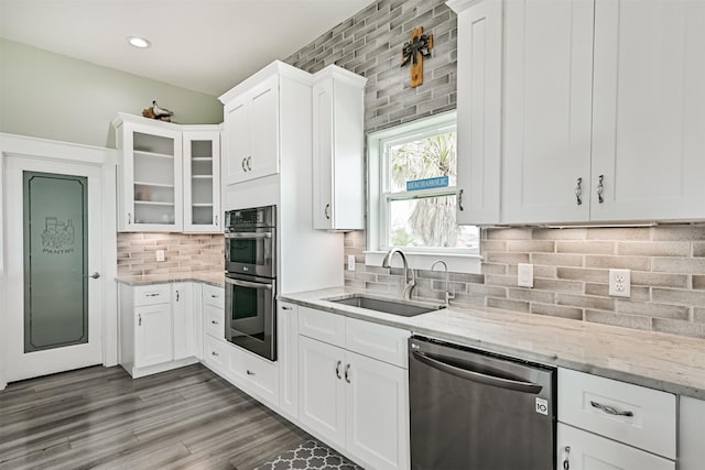 16631 Jean Lafitte Rd, Galveston, TX 77554 - kitchen featuring a sink, appliances with stainless steel finishes, white cabinetry, light stone countertops, and glass insert cabinets
