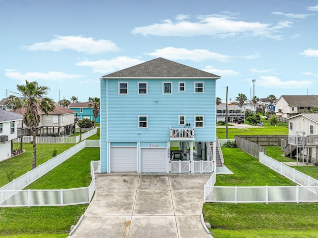 16631 Jean Lafitte Rd, Galveston, TX 77554 - rear view of property with stairs, a garage, concrete driveway, and a yard