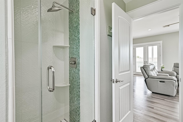 16631 Jean Lafitte Rd, Galveston, TX 77554 - bathroom with wood finished floors, a shower stall, and french doors
