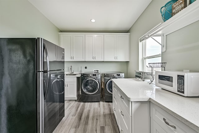 16631 Jean Lafitte Rd, Galveston, TX 77554 - laundry area featuring washer and dryer, a sink, light wood-type flooring, and recessed lighting