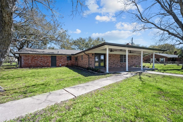 6211 Sjolander Rd, Baytown, TX 77521 - view of front of home featuring a ceiling fan, a front yard, brick siding, and french doors