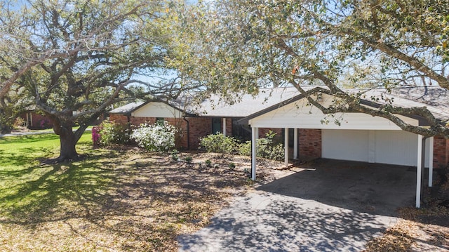 6211 Sjolander Rd, Baytown, TX 77521 - ranch-style home featuring a carport, brick siding, concrete driveway, and a front lawn