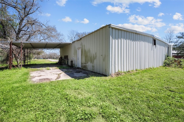 6211 Sjolander Rd, Baytown, TX 77521 - view of outdoor structure featuring driveway and an attached carport