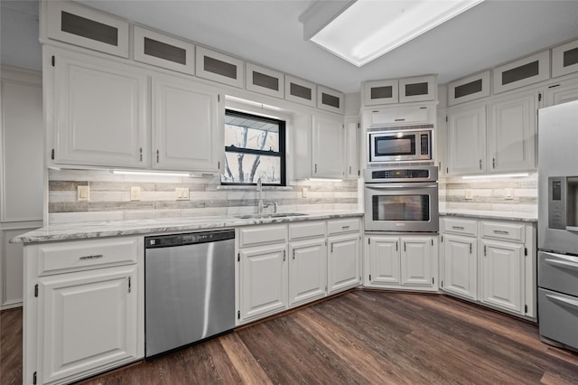 6211 Sjolander Rd, Baytown, TX 77521 - kitchen with stainless steel appliances, a sink, white cabinets, dark wood-style floors, and light stone counters