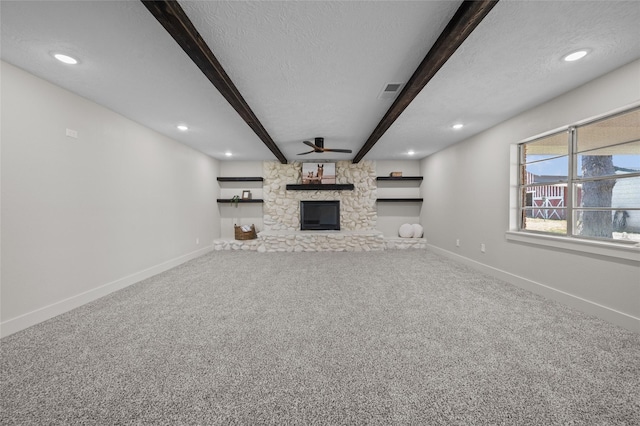 6211 Sjolander Rd, Baytown, TX 77521 - unfurnished living room with beamed ceiling, baseboards, a fireplace, a textured ceiling, and carpet floors