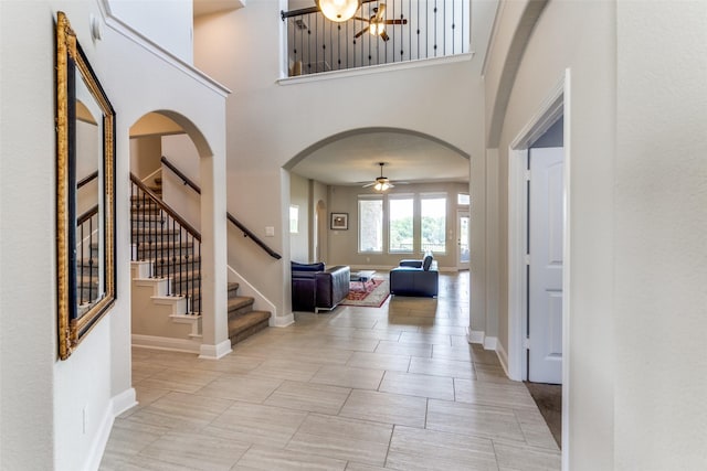27314 Dana Crk, Boerne, TX 78015 - entryway with arched walkways, ceiling fan, stairs, a high ceiling, and baseboards