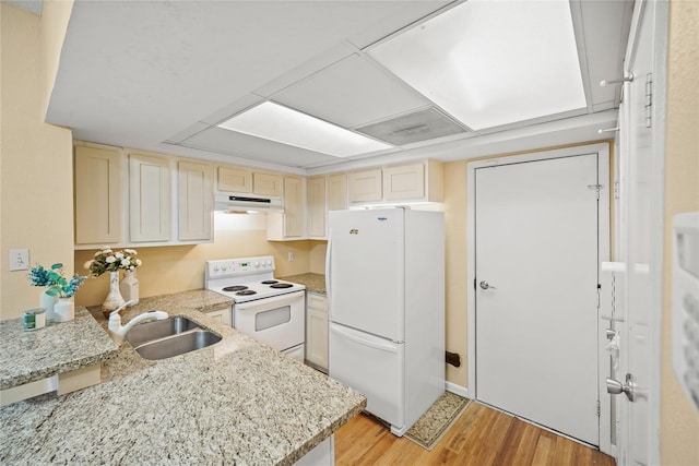 1829 Augusta Dr Unit 33, Houston, TX 77057 - kitchen featuring white appliances, under cabinet range hood, light wood-style flooring, and light stone countertops