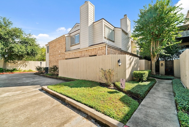 1829 Augusta Dr Unit 33, Houston, TX 77057 - view of side of home featuring a chimney and brick siding