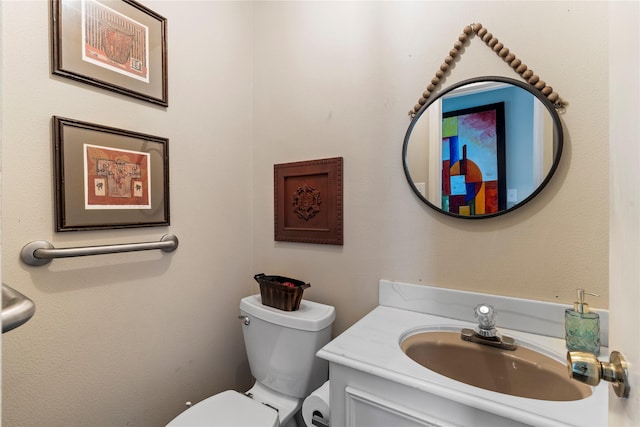 bathroom featuring toilet and vanity