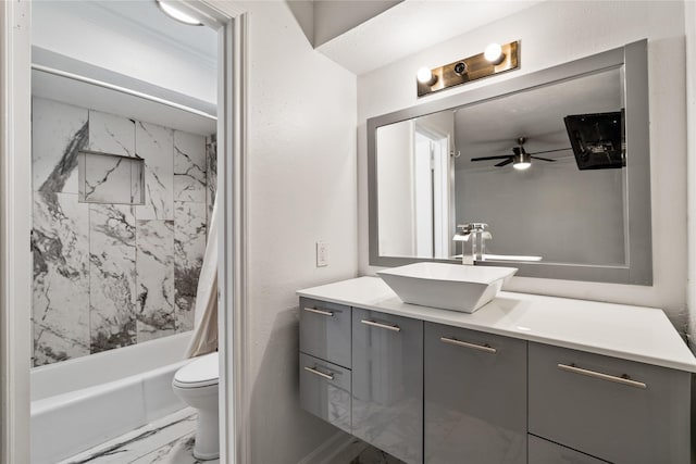 bathroom featuring marble look tile flooring, ceiling fan, vanity, toilet, and shower / bathtub combination with curtain
