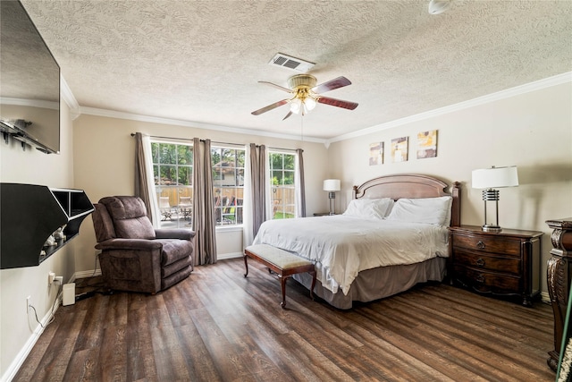 bedroom featuring wood finished floors, baseboards, a textured ceiling, crown molding, and ceiling fan