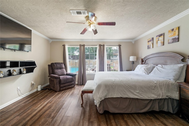 bedroom featuring wood finished floors, a textured ceiling, ornamental molding, ceiling fan, and baseboards