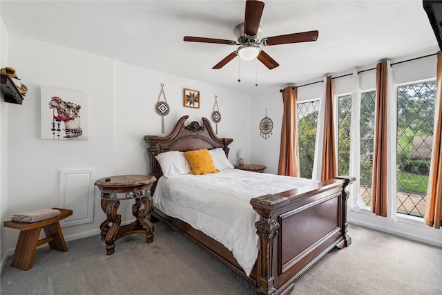 bedroom with light carpet, multiple windows, a ceiling fan, and baseboards