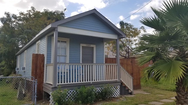 1207 29th St, Galveston, TX 77550 - view of property exterior with a porch and fence