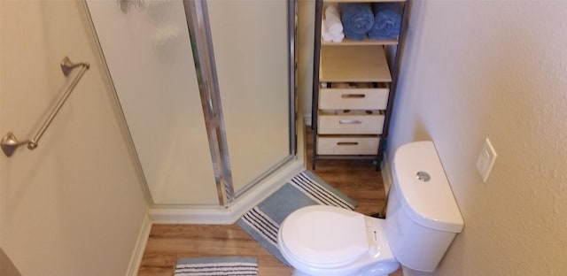 1207 29th St, Galveston, TX 77550 - full bath featuring wood finished floors, a stall shower, toilet, and baseboards