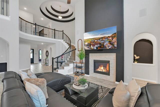 15606 Upper Lochton Dr, Humble, TX 77346 - tiled living room featuring a high ceiling, stairs, a fireplace, recessed lighting, and baseboards