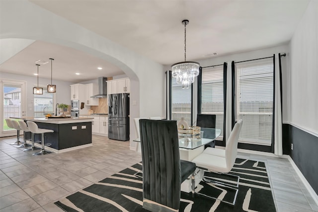 15606 Upper Lochton Dr, Humble, TX 77346 - dining space featuring arched walkways, a chandelier, and recessed lighting