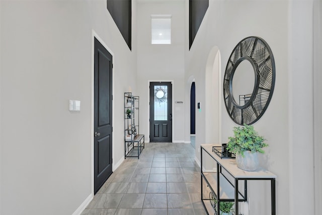 15606 Upper Lochton Dr, Humble, TX 77346 - entrance foyer featuring baseboards, a high ceiling, and arched walkways