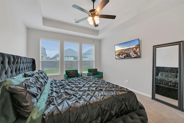 15606 Upper Lochton Dr, Humble, TX 77346 - carpeted bedroom featuring a raised ceiling, a ceiling fan, and baseboards