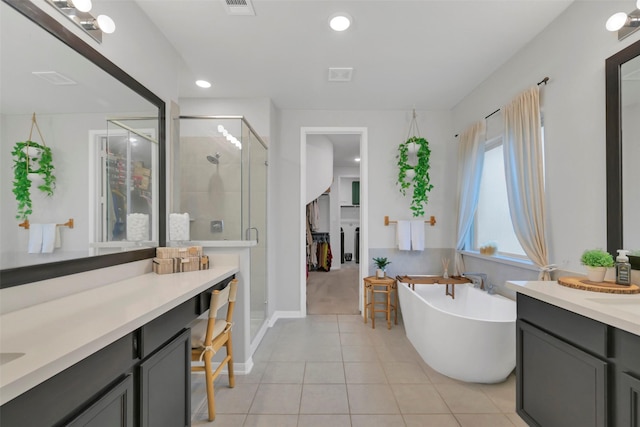 15606 Upper Lochton Dr, Humble, TX 77346 - bathroom featuring a shower stall, a freestanding tub, tile patterned floors, vanity, and recessed lighting