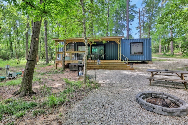 275 Fairview E, Livingston, TX 77351 - back of house featuring a fire pit, board and batten siding, and a deck
