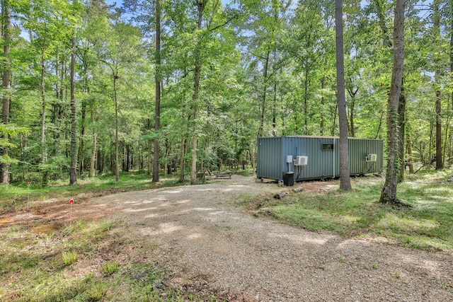 275 Fairview E, Livingston, TX 77351 - view of yard with an outdoor structure and a view of trees