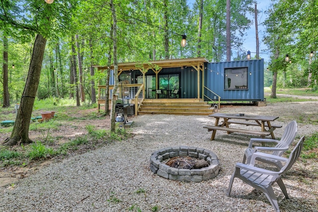 275 Fairview E, Livingston, TX 77351 - rear view of property featuring an outdoor fire pit and board and batten siding